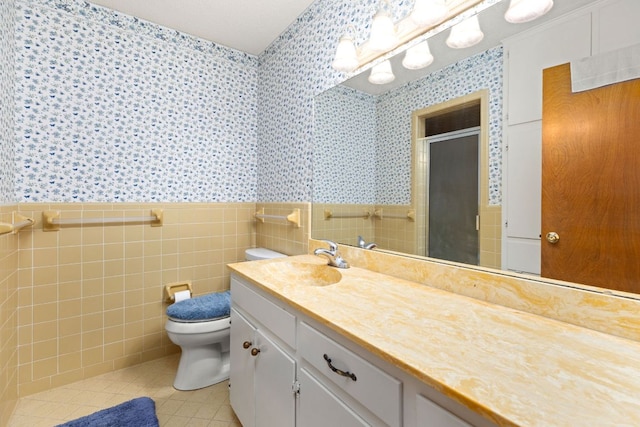 307 S 7th St, Pflugerville, TX 78660 - bathroom with tile walls, a shower stall, wallpapered walls, tile patterned floors, and toilet