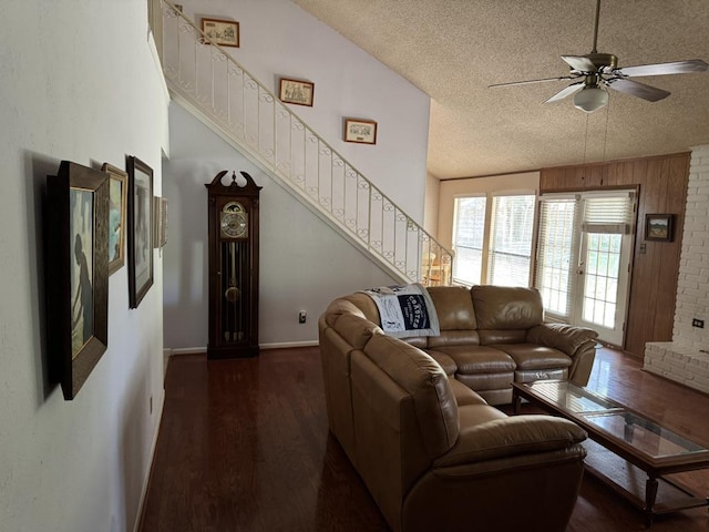 11202 Balcones Woods Cv, Austin, TX 78759 - living area featuring a textured ceiling, wood finished floors, ceiling fan, and stairway
