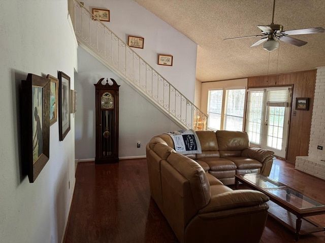 11202 Balcones Woods Cv, Austin, TX 78759 - living room featuring a textured ceiling, wood finished floors, ceiling fan, and stairway