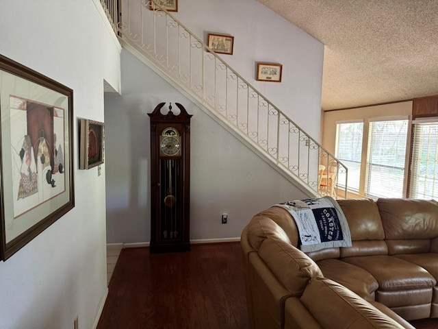 11202 Balcones Woods Cv, Austin, TX 78759 - living room featuring stairs, a textured ceiling, and wood finished floors