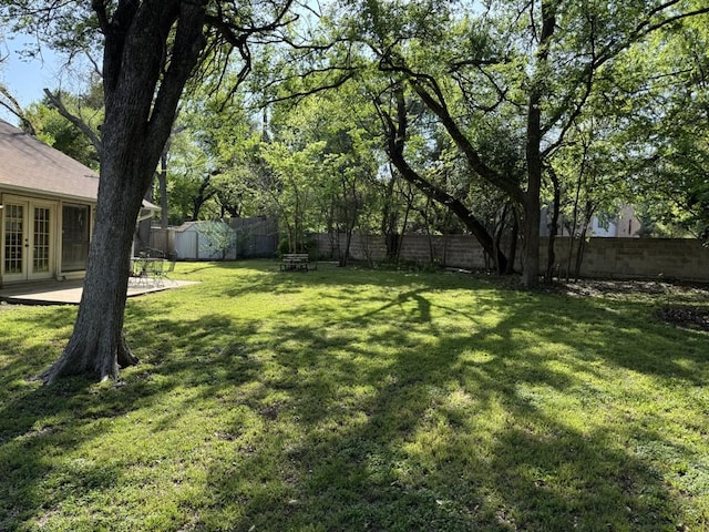 11202 Balcones Woods Cv, Austin, TX 78759 - fenced backyard featuring french doors