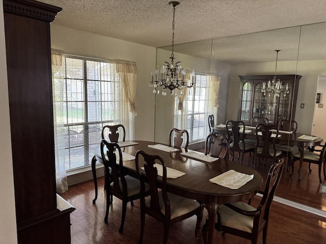 11202 Balcones Woods Cv, Austin, TX 78759 - dining room with a chandelier, wood finished floors, and a textured ceiling