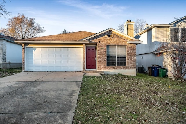 8802 Peppergrass Cv, Austin, TX 78745 - single story home with driveway, a chimney, brick siding, and an attached garage