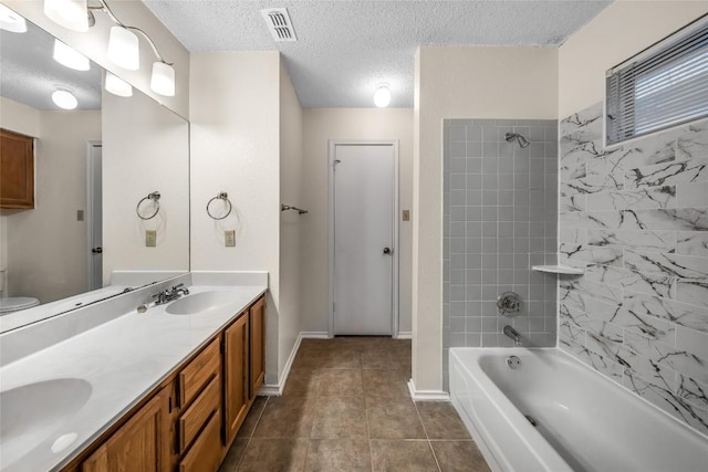 8802 Peppergrass Cv, Austin, TX 78745 - full bath featuring  shower combination, double vanity, a textured ceiling, and tile patterned floors