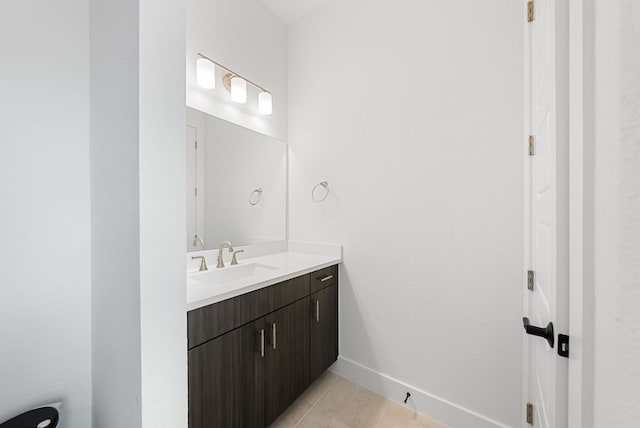 bathroom with vanity, tile patterned flooring, and baseboards