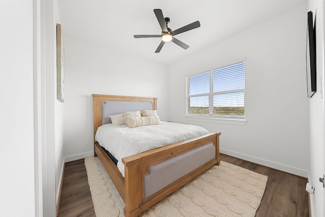 bedroom featuring baseboards, a ceiling fan, and wood finished floors