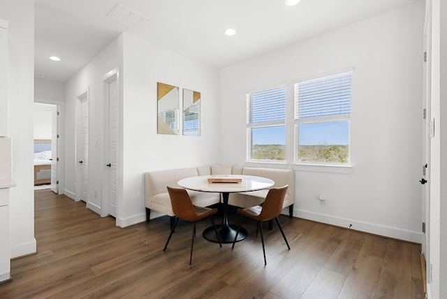 dining space with baseboards, recessed lighting, wood finished floors, and visible vents