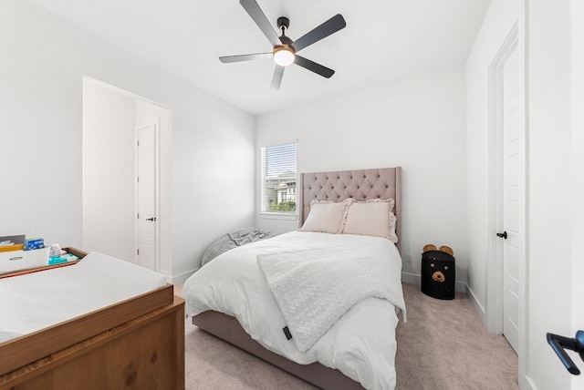bedroom featuring a ceiling fan, baseboards, and light carpet
