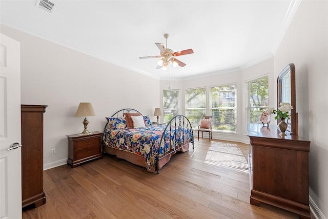 10005 Cormorant Cv, Austin, TX 78730 - bedroom with wood finished floors, baseboards, ornamental molding, and ceiling fan