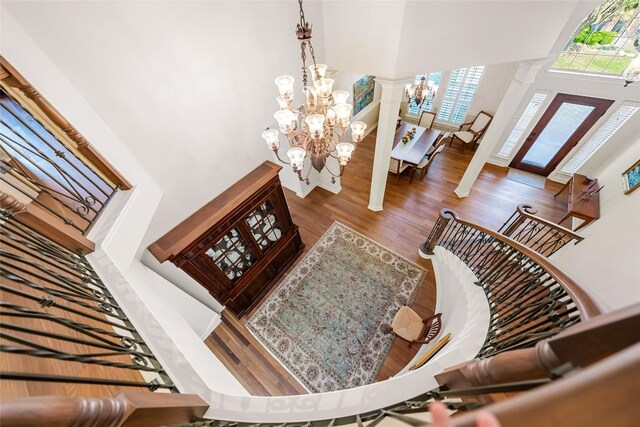 10005 Cormorant Cv, Austin, TX 78730 - living area with a chandelier, decorative columns, a high ceiling, and wood finished floors