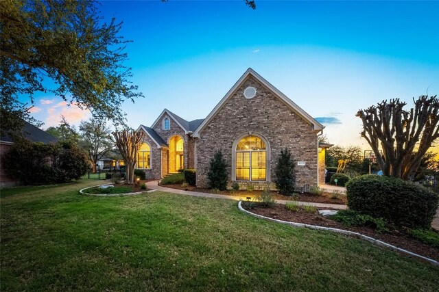 10005 Cormorant Cv, Austin, TX 78730 - traditional-style home with a yard and brick siding