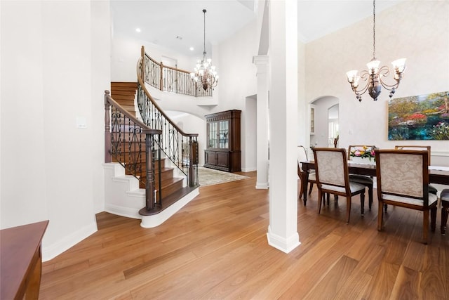 10005 Cormorant Cv, Austin, TX 78730 - foyer featuring a chandelier, arched walkways, baseboards, and a towering ceiling
