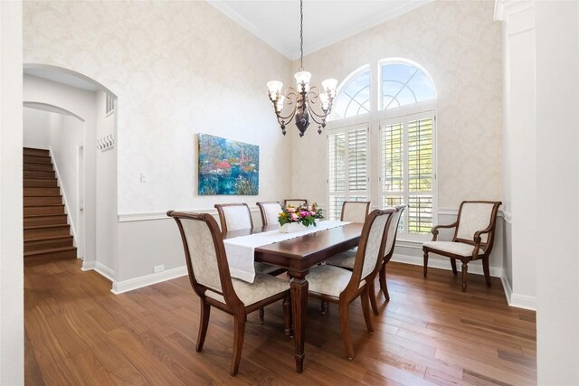 10005 Cormorant Cv, Austin, TX 78730 - dining space featuring wood finished floors, stairway, baseboards, a chandelier, and ornamental molding