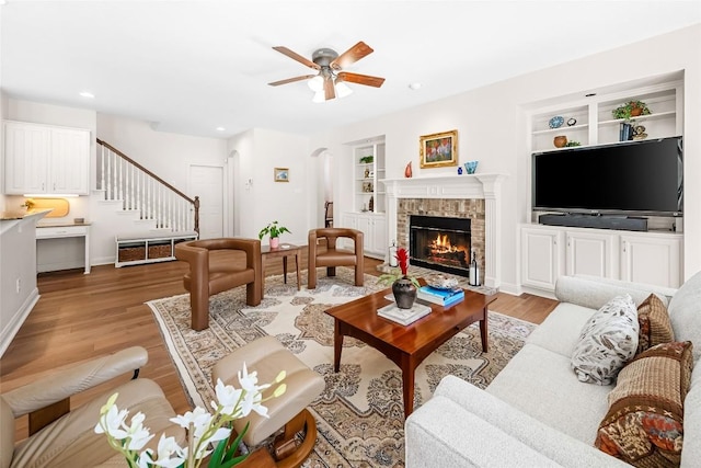 10005 Cormorant Cv, Austin, TX 78730 - living area with built in features, light wood-style flooring, stairway, ceiling fan, and baseboards