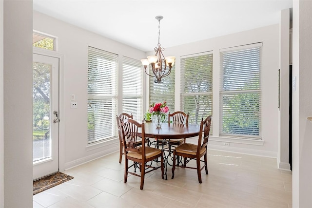 10005 Cormorant Cv, Austin, TX 78730 - dining area featuring a chandelier, baseboards, and light tile patterned floors