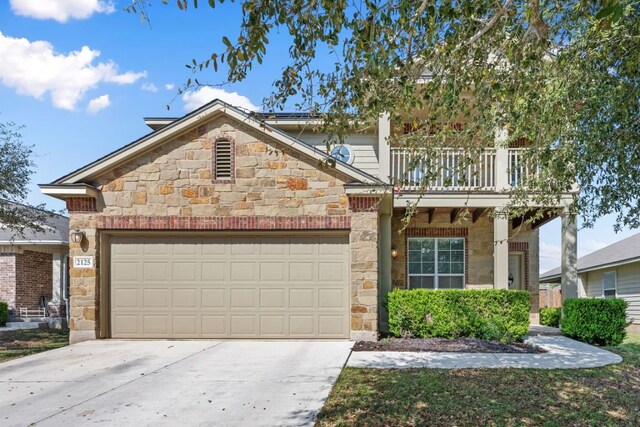 2125 Conner Dr, New Braunfels, TX 78130 - view of front of home with stone siding, concrete driveway, a garage, and a balcony