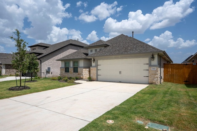 341 Fawn River Run, Kyle, TX 78640 - view of front of property featuring stone siding, a shingled roof, and a garage