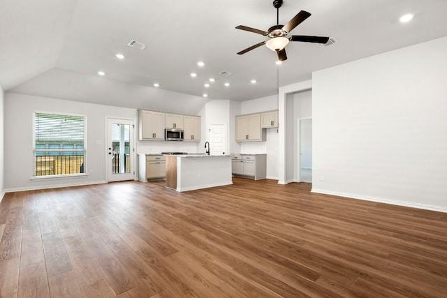341 Fawn River Run, Kyle, TX 78640 - unfurnished living room with vaulted ceiling, ceiling fan, wood finished floors, baseboards, and recessed lighting