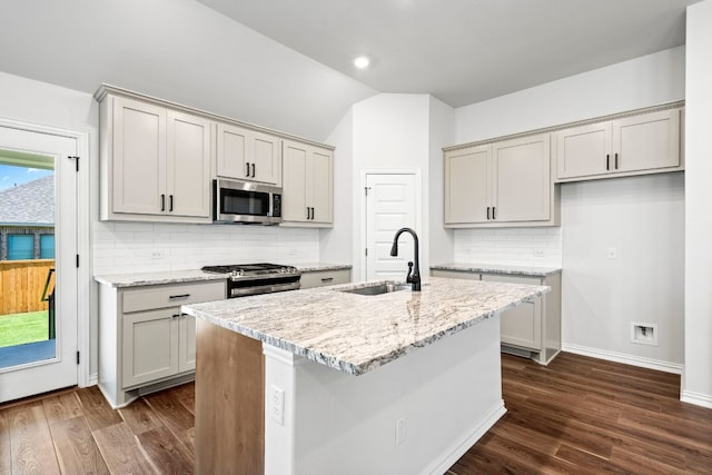 341 Fawn River Run, Kyle, TX 78640 - kitchen featuring a sink, appliances with stainless steel finishes, dark wood finished floors, backsplash, and vaulted ceiling