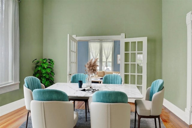 dining room with baseboards and wood finished floors