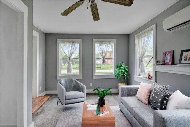 living room featuring a wealth of natural light, a wall unit AC, baseboards, and a ceiling fan