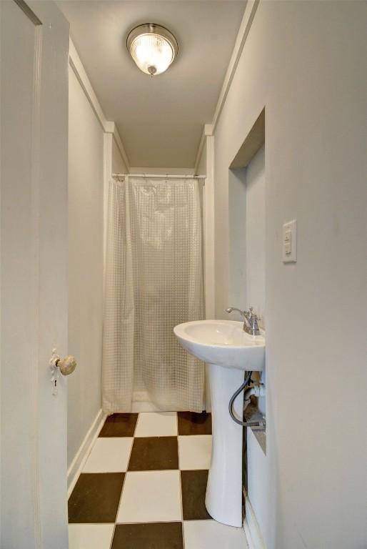 full bathroom with baseboards, tile patterned floors, and a shower with shower curtain