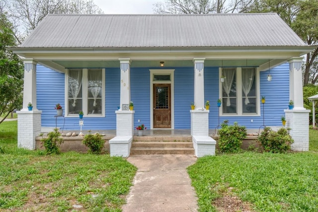 bungalow with metal roof and a porch