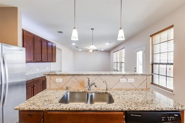 868 Water Hyacinth Loop, Leander, TX 78641 - kitchen featuring freestanding refrigerator, decorative backsplash, dishwashing machine, and decorative light fixtures