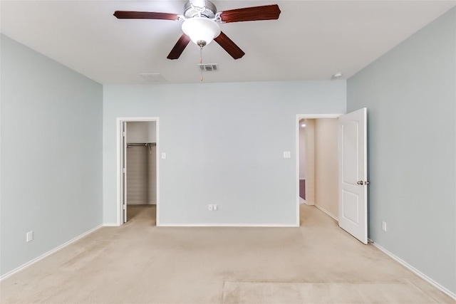 868 Water Hyacinth Loop, Leander, TX 78641 - unfurnished bedroom with light colored carpet, a spacious closet, and a ceiling fan