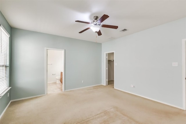 868 Water Hyacinth Loop, Leander, TX 78641 - unfurnished bedroom with multiple windows, light colored carpet, a spacious closet, and ensuite bath