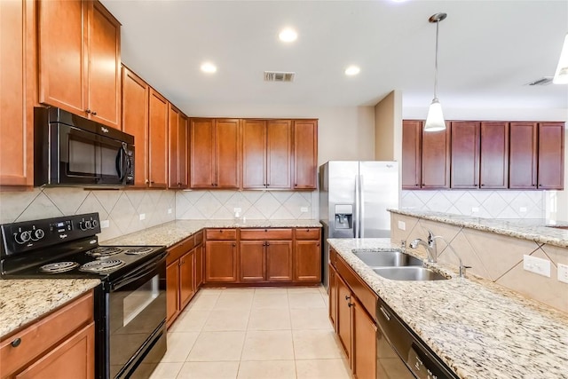 868 Water Hyacinth Loop, Leander, TX 78641 - kitchen featuring black appliances, tasteful backsplash, light tile patterned floors, hanging light fixtures, and light stone countertops