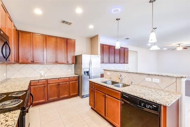 868 Water Hyacinth Loop, Leander, TX 78641 - kitchen with black appliances, decorative backsplash, hanging light fixtures, an island with sink, and light stone countertops
