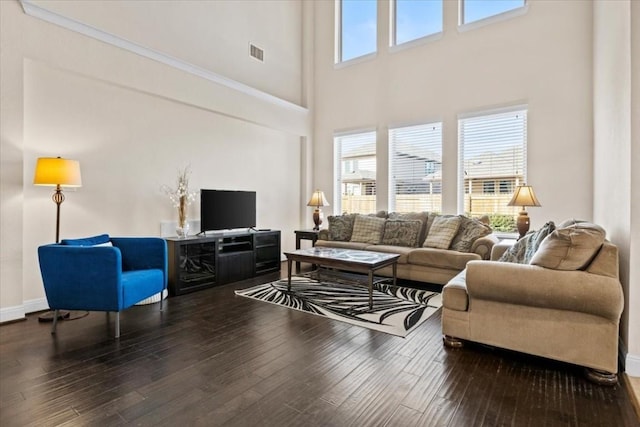 2316 Centennial Loop, Round Rock, TX 78665 - living room featuring a towering ceiling, healthy amount of natural light, wood-type flooring, and baseboards