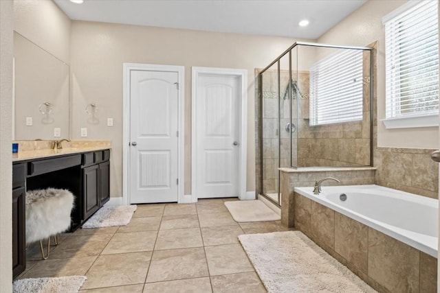 2316 Centennial Loop, Round Rock, TX 78665 - bathroom featuring vanity, a bath, a shower stall, tile patterned flooring, and recessed lighting