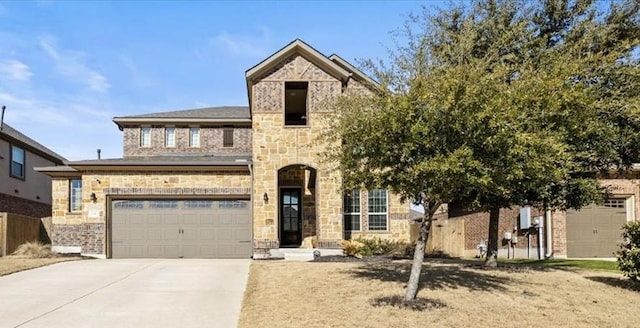 2316 Centennial Loop, Round Rock, TX 78665 - view of front of house with driveway, a garage, and stone siding