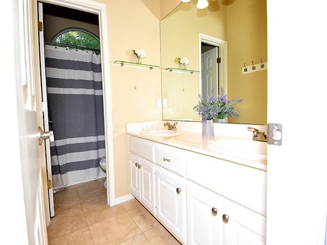 159 Moku Manu Dr, Bastrop, TX 78602 - full bath featuring double vanity, tile patterned floors, and curtained shower