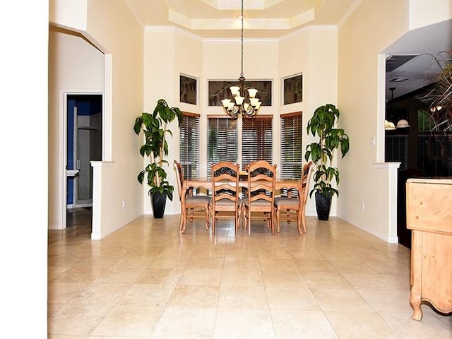 159 Moku Manu Dr, Bastrop, TX 78602 - dining room with a chandelier, crown molding, a tray ceiling, light tile patterned flooring, and a towering ceiling