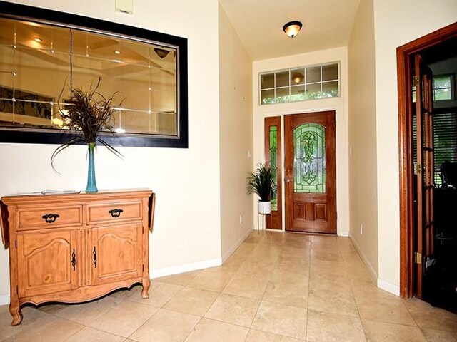 159 Moku Manu Dr, Bastrop, TX 78602 - foyer featuring light tile patterned floors and plenty of natural light