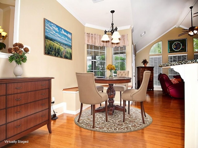 159 Moku Manu Dr, Bastrop, TX 78602 - dining room with a chandelier, wood finished floors, crown molding, a ceiling fan, and vaulted ceiling