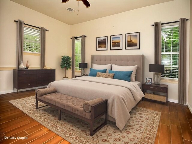 159 Moku Manu Dr, Bastrop, TX 78602 - bedroom featuring wood finished floors, multiple windows, and ceiling fan