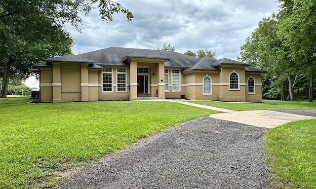 159 Moku Manu Dr, Bastrop, TX 78602 - view of front of property featuring stucco siding and a front yard