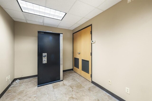 401 Main St, Blanco, TX 78606 - spare room with a paneled ceiling and baseboards