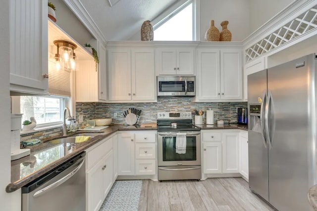 16525 Jamaica Cove Rd, Jamaica Beach, TX 77554 - kitchen featuring lofted ceiling, tasteful backsplash, a sink, and stainless steel appliances