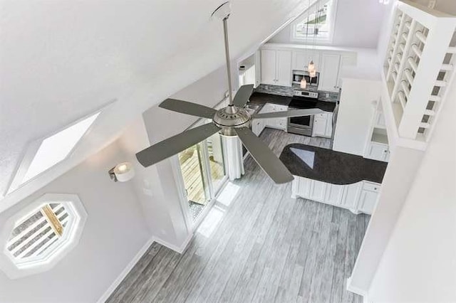 16525 Jamaica Cove Rd, Jamaica Beach, TX 77554 - interior space with visible vents, baseboards, wood finished floors, a ceiling fan, and lofted ceiling