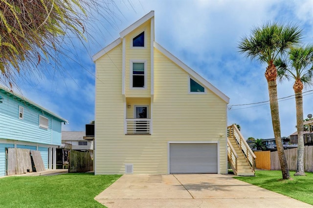 16525 Jamaica Cove Rd, Jamaica Beach, TX 77554 - back of house with fence, a garage, concrete driveway, stairway, and a lawn