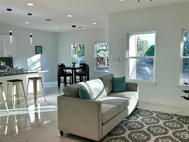 living room with baseboards, marble finish floor, visible vents, and recessed lighting