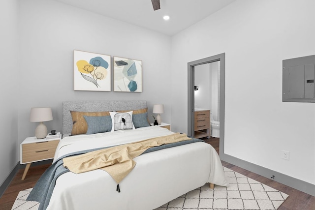 2450 Wickersham Ln Unit 2021, Austin, TX 78741 - bedroom with electric panel, wood finished floors, baseboards, recessed lighting, and connected bathroom