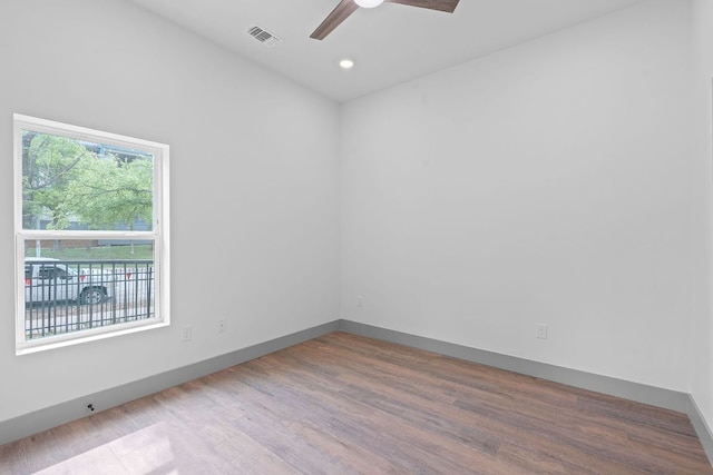 2450 Wickersham Ln Unit 2021, Austin, TX 78741 - spare room featuring ceiling fan, wood finished floors, baseboards, and recessed lighting