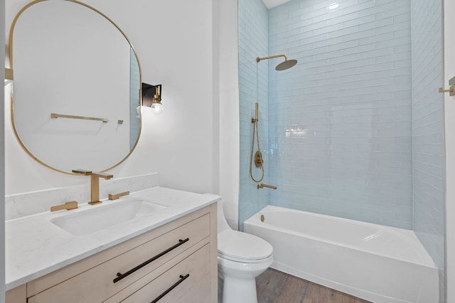 2450 Wickersham Ln Unit 2021, Austin, TX 78741 - bathroom with toilet, wood finished floors, vanity, and washtub / shower combination
