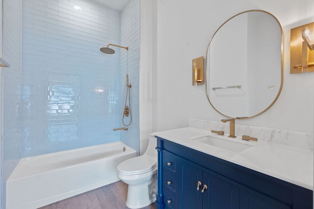 2450 Wickersham Ln Unit 2021, Austin, TX 78741 - bathroom with wood finished floors, toilet, vanity, and shower / bathtub combination